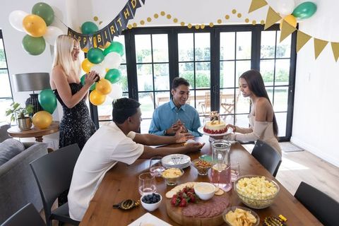Friends Celebrating Birthday with Cake at Home Party