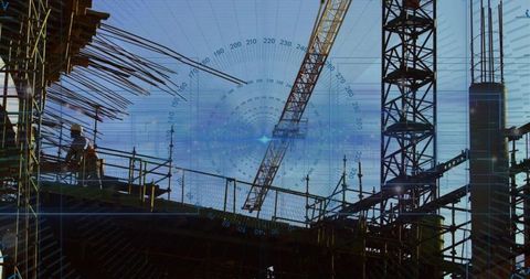 Constructing urban high-rise silhouette with tower crane and workers wearing hard hats