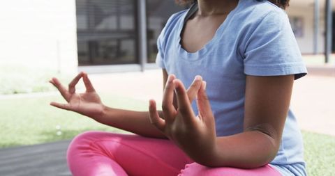 Girl Meditating Outdoors in Yoga Pose Embracing Tranquility
