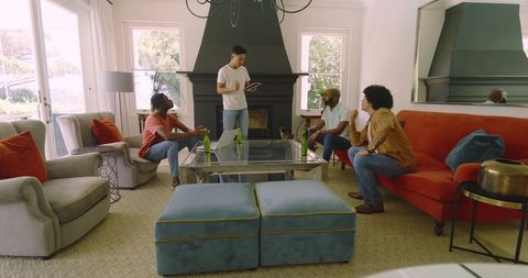 Friends Gathering in Cozy Living Room with Drinks and Laughter