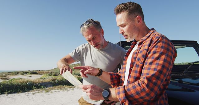 Two Men Exploring Outdoors with Map on Sunny Day - Download Free Stock Images Pikwizard.com