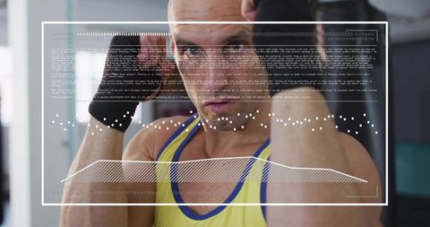 Mid adult male shadowboxing with hud overlay, wearing yellow tank and black wrist wraps