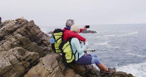 Senior Couple Hiking Near Sea Taking Selfie by Rocky Coastline - Download Free Stock Images Pikwizard.com