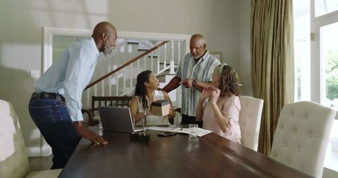 Senior adults celebrating together around dining table