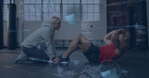 Female trainer holding client feet while athlete doing sit-ups with fitness data overlays