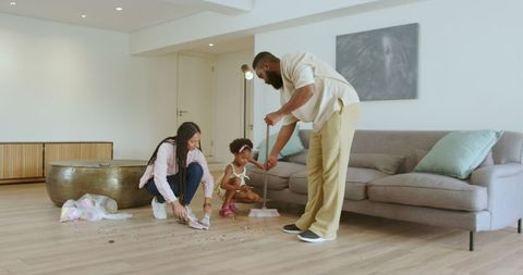 Happy Family Bonding Time: Cleaning Living Room Together at Home