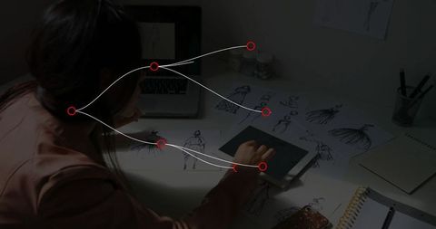 Fashion designer engaged with digital sketching in studio