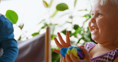 Joyful Kids Playing with Colorful Clay at Home