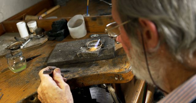 Experienced Craftsman Working on Bench Soldering Jewelry - Download Free Stock Images Pikwizard.com