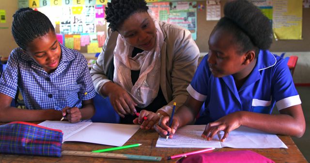 Teacher Guiding Students During Classroom Activity - Download Free Stock Images Pikwizard.com