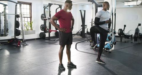 Personal trainer assisting client with resistance band workout