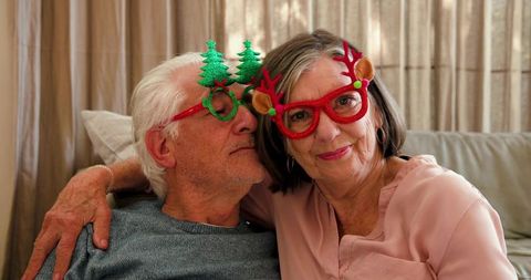 Senior Couple Enjoying Holiday Season with Festive Glasses