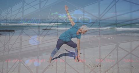 Mature woman practicing yoga on beach with overlay of business graphics