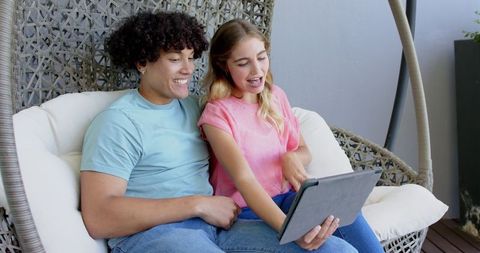 Couple enjoys quality time using tablet at home