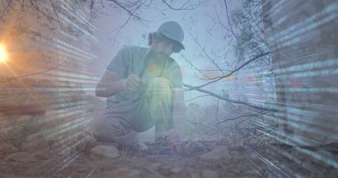 Innovative geologist analyzing rock sample with tech code overlay