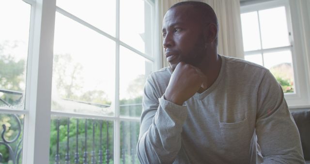 Reflective Man Gazing Out Window at Home - Download Free Stock Images Pikwizard.com