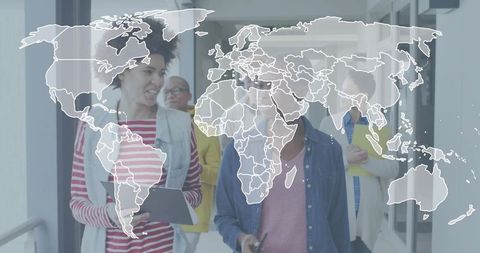 Multicultural team walking through modern office corridor with digital world map overlay