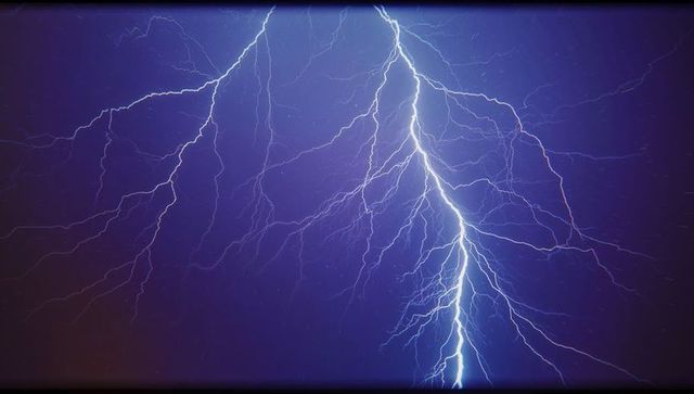 Vibrant Lightning Bolt Illuminating Night Sky