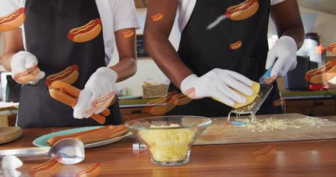 Dual Hands Preparing Delicious Hot Dogs in Kitchen
