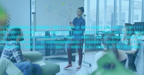 Female Presenter Leading Team Brainstorming with Binary Data Overlay in Modern Office Workspace