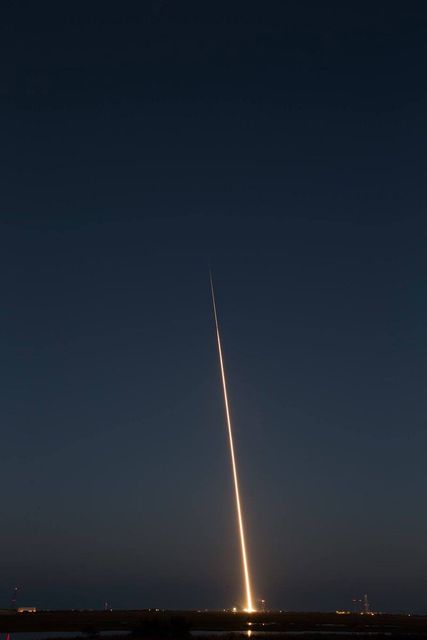 This stunning image captures the fiery ascent of a Black Brant IX suborbital rocket launched at NASA's Wallops Flight Facility. Taken on October 7, 2015, the photo highlights the powerful trail of light piercing the night sky as part of a test to evaluate the performance of the secondary stage motor. Use this image to visually represent scientific advancement, aerospace engineering, or space exploration in educational materials, news articles, or promotional content related to NASA's missions.