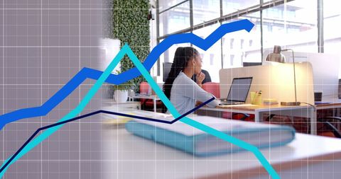 Businesswoman analyzing digital graphs in modern office