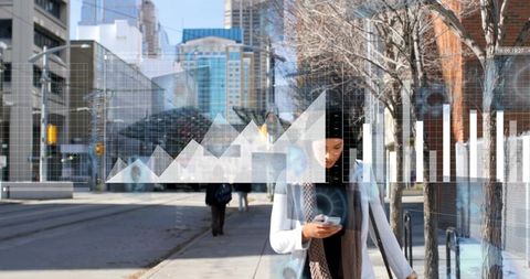 Woman wearing headscarf walking with smartphone in downtown with futuristic data overlay