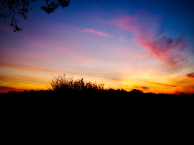 Vibrant Sunset Sky Over Silhouetted Landscape - Download Free Stock Photos Pikwizard.com