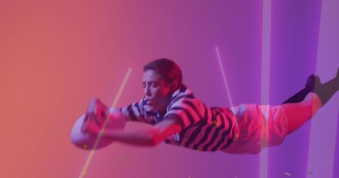Female Rugby Player in Mid-Air with Vibrant Neon Background