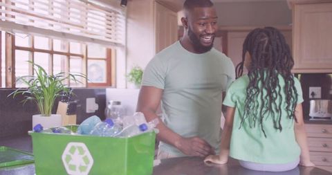 Father Teaching Daughter Recycling in Kitchen for Eco-Friendly Living