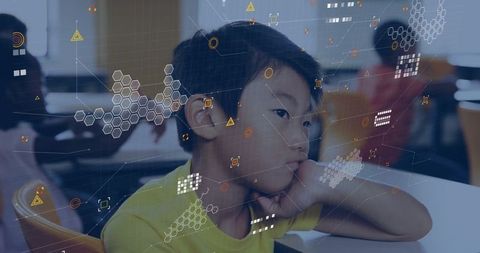 Boy engaging with digital interfaces in innovative classroom