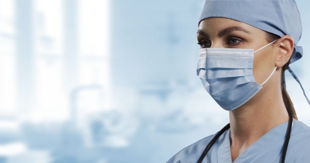 Caucasian female surgeon in scrubs wearing a face mask with a blurred hospital background. Ideal for use in medical reports, healthcare promotions, professional medical blogs, and healthcare brochures.