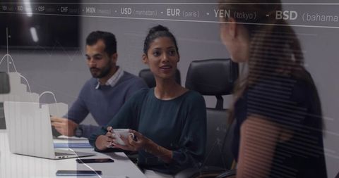 Holding cup while discussing financial analytics and team strategy in modern boardroom meeting