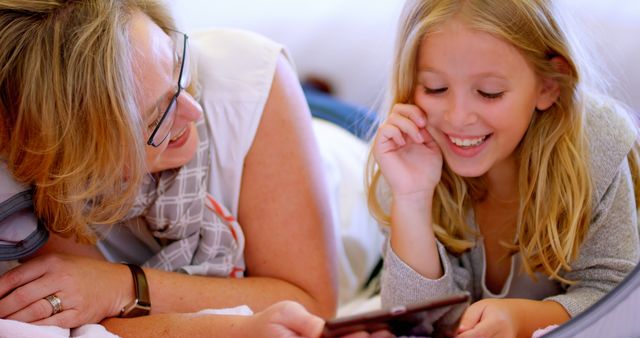 Mother and Daughter Laughing Together Using Tablet - Download Free Stock Images Pikwizard.com