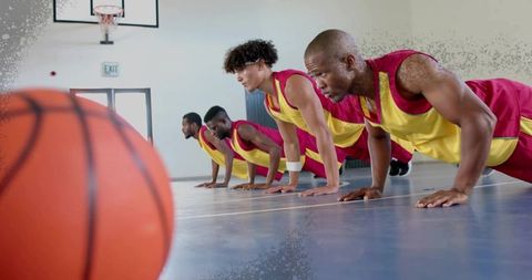 Basketball Team Exercising with Push-Ups on Court