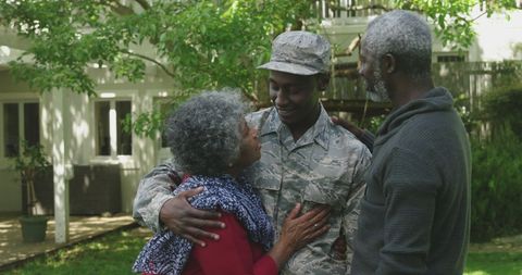 Emotional Homecoming of Soldier with Family in Garden - Download Free Stock Images Pikwizard.com