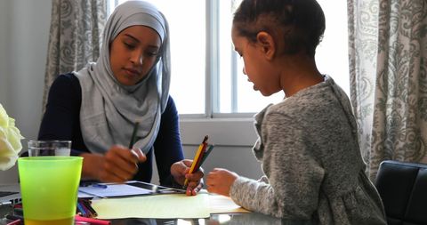 Mother Helping Child with Homework at Home for Bonding and Support