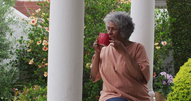 Elderly Woman Enjoying Coffee on Porch Surrounded by Greenery - Download Free Stock Images Pikwizard.com