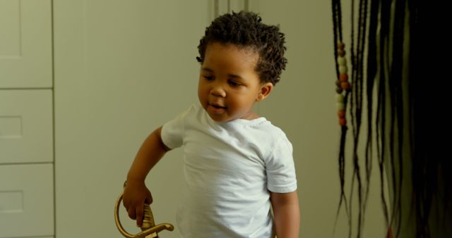 A young child wearing a white shirt holds a toy sword while exploring indoors. Ideal for illustrating themes of childhood curiosity, playtime, and innocent exploration in a home environment. Perfect for parenting blogs, educational materials, and home life illustrations.