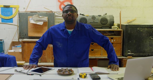 Confident Male Carpenter in Blue Workwear in Workshop - Download Free Stock Images Pikwizard.com