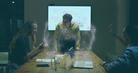 Team presenting holographic data visualization during collaborative business meeting