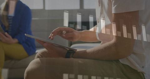 Man Analyzing Digital Data Projection on Tablet in Office Setting