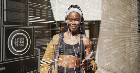 Black woman in activewear holding smartphone with hud tech overlay on sunny urban campus