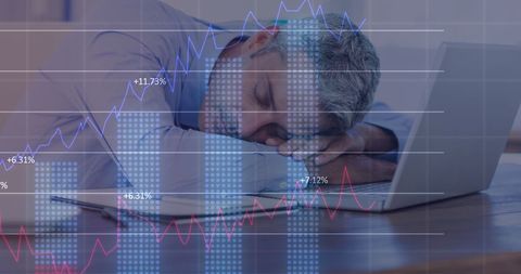 Exhausted businessman sleeping amidst data overload