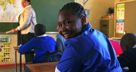 Happy African American Schoolgirl Smiling Inside Classroom