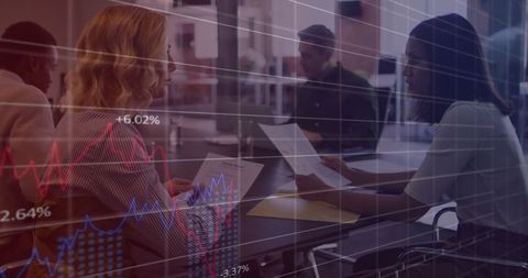 Diverse colleagues analyzing business data with graphical overlay
