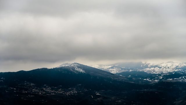 Snow-Covered Mountain Peaks and Dense Cloudy Sky - Download Free Stock Photos Pikwizard.com