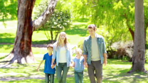 Happy Family Strolling Through Sunny Park