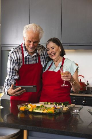 Senior Retirees Cooking Together in Modern Kitchen