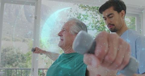 Senior performing dumbbell raises in physical therapy with caregiver and digital monitoring